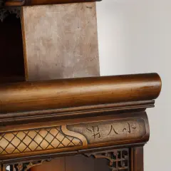Détail d'un meuble en bois sculpté, orné de motifs géométriques et de caractères chinois, rappelant l'art de Gabriel Viardot.