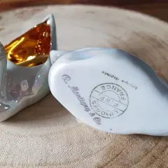 Deux cygnes en porcelaine irisée, l'un avec l'intérieur doré. L'un porte la marque pour reconnaître estampille porcelaine Limoges France.
