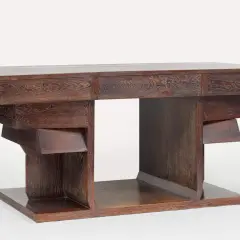 Bureau en chêne sculpté par Pierre Legrain, aux lignes géométriques audacieuses et aux tiroirs dissimulés.