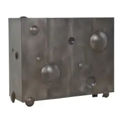 Commode en métal patiné, œuvre de Mattia Bonetti, aux formes cubiques et sphériques, évoquant un fromage ou une planète.