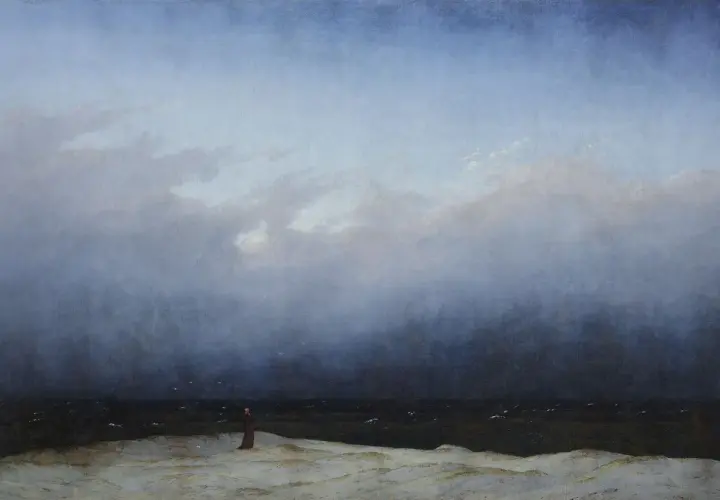 Une figure solitaire contemple la mer agitée sous un ciel menaçant, une scène typique des œuvres d'art de Caspar David Friedrich.