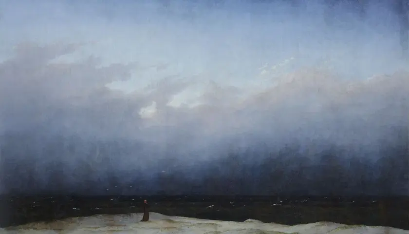 Une figure solitaire contemple la mer agitée sous un ciel menaçant, une scène typique des œuvres d'art de Caspar David Friedrich.