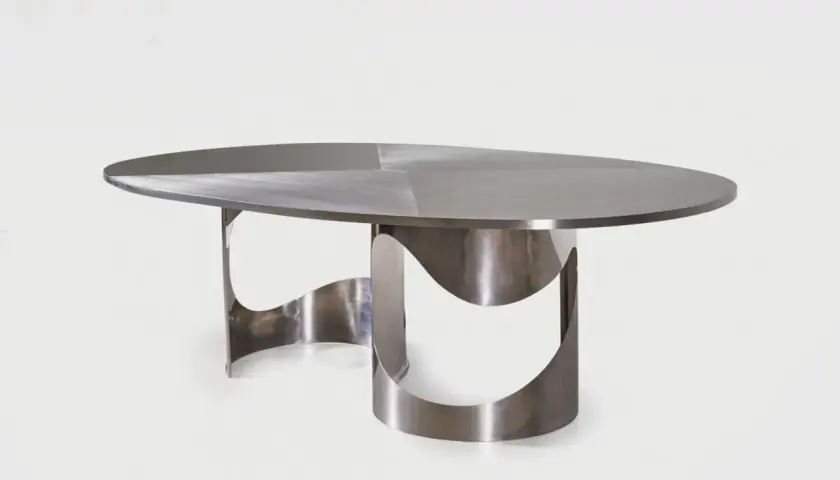Table design by Maria Pergay, en métal brossé, aux formes organiques et sculpturales.