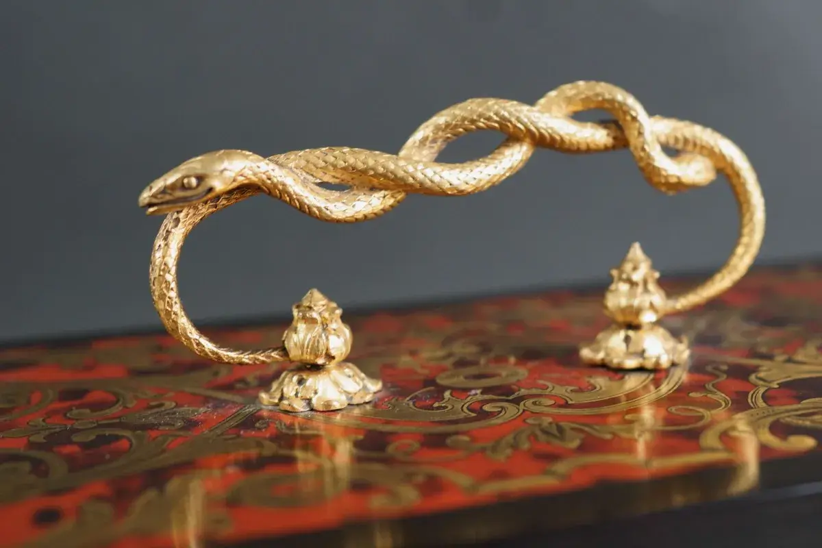 Poignée en bronze doré, un serpent enroulé, signé Susse Frères, sur un coffret orné.