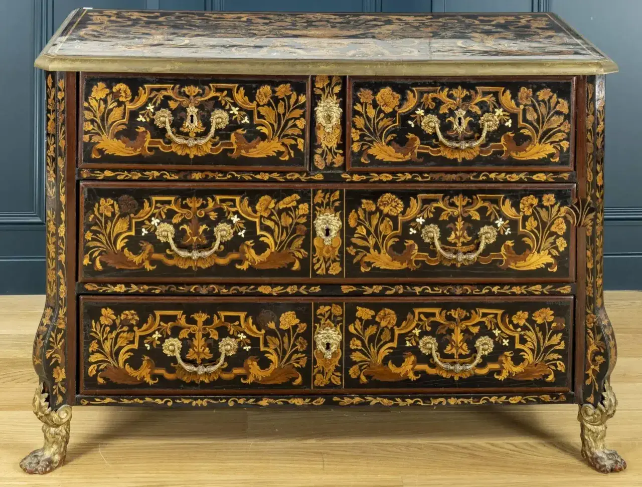 Commode ancienne ornée de marqueterie florale complexe et de pieds griffus. On dit que les meubles anciens ne valent plus rien, mais cette pièce est un chef-d'œuvre.